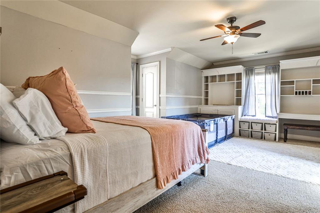 872 Pathview Court Dacula, GA 30019 - Photo 26 of 62 a bedroom with a bed next to a window with a chandelier