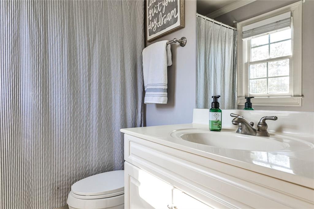 872 Pathview Court Dacula, GA 30019 - Photo 30 of 62 a bathroom with a sink a toilet and a window