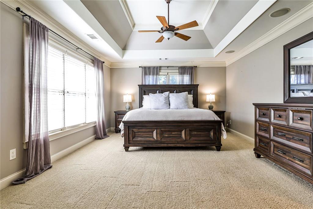 872 Pathview Court Dacula, GA 30019 - Photo 33 of 62 a bedroom with a bed and a chandelier