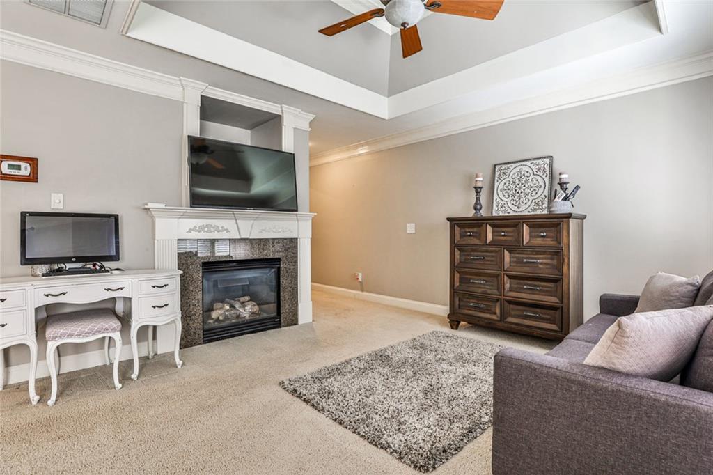 872 Pathview Court Dacula, GA 30019 - Photo 34 of 62 a living room with furniture a flat screen tv and a fireplace