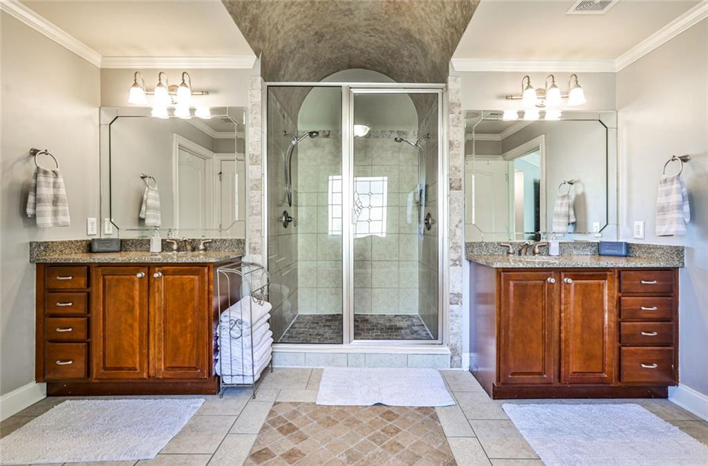 872 Pathview Court Dacula, GA 30019 - Photo 36 of 62 a spacious bathroom with a granite countertop sink a mirror and a shower