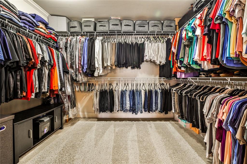 872 Pathview Court Dacula, GA 30019 - Photo 39 of 62 a view of walk in closet with clothes and shoes