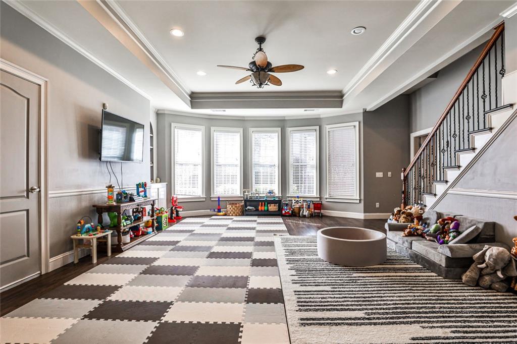 872 Pathview Court Dacula, GA 30019 - Photo 40 of 62 a living room with furniture a chandelier and a flat screen tv