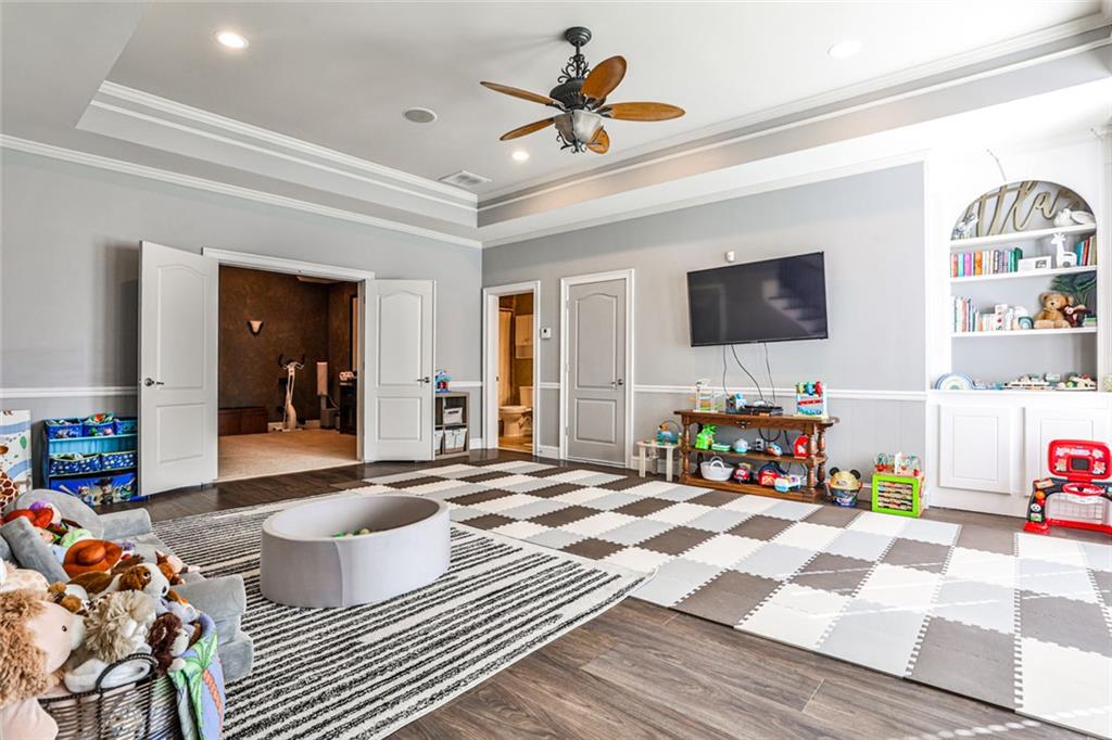 872 Pathview Court Dacula, GA 30019 - Photo 41 of 62 a bedroom with furniture a flat screen tv and a fireplace