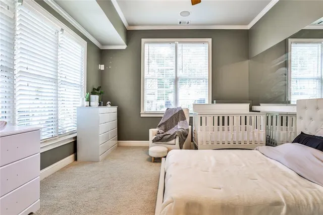 a view of swimming pool with outdoor seating and trees in the background