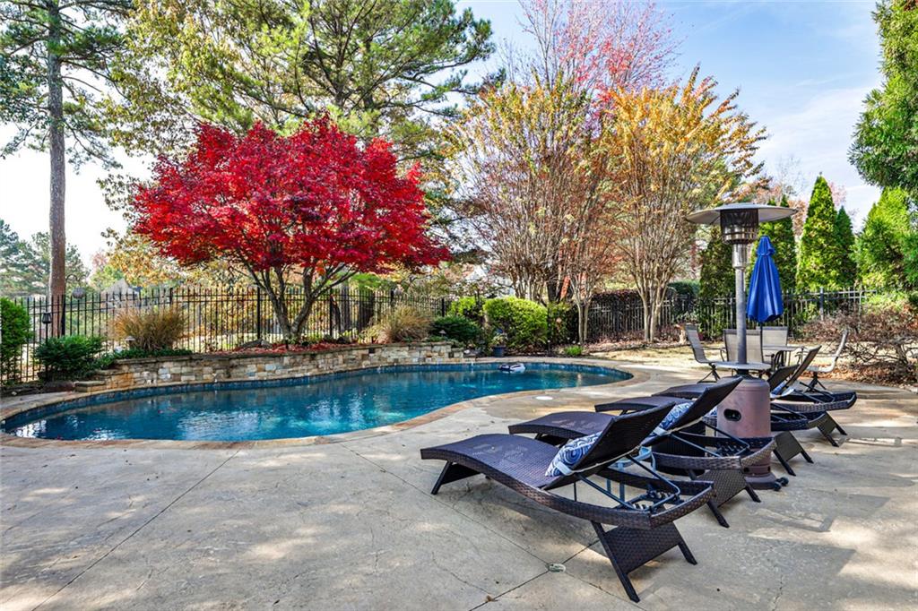 872 Pathview Court Dacula, GA 30019 - Photo 50 of 62 a view of swimming pool with outdoor seating and plants