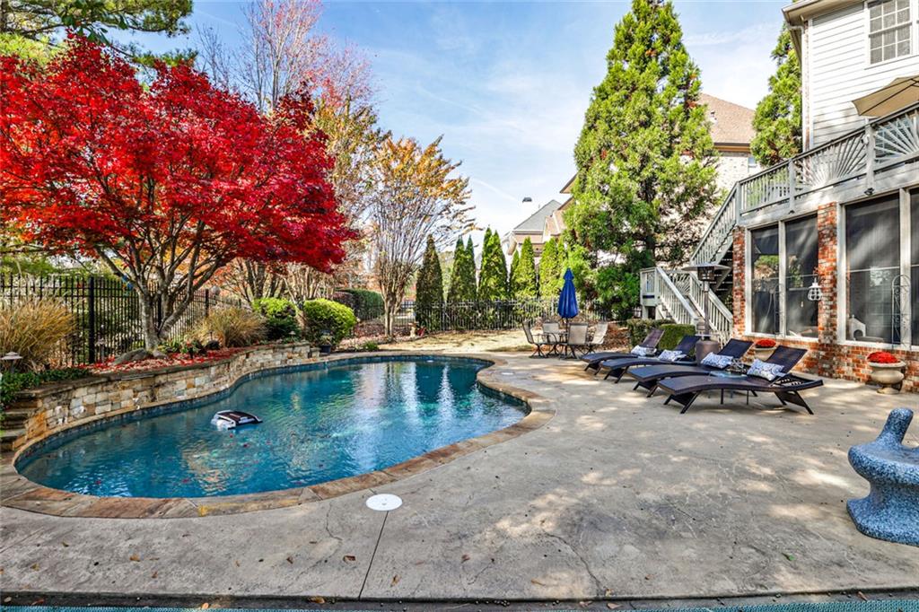 872 Pathview Court Dacula, GA 30019 - Photo 51 of 62 a view of swimming pool with outdoor seating and trees in the background