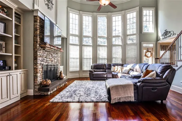 a living room with furniture a flat screen tv and a fireplace