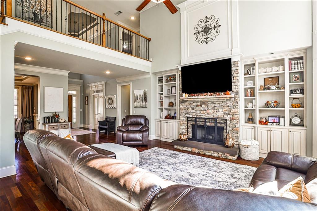 872 Pathview Court Dacula, GA 30019 - Photo 9 of 62 a living room with furniture a flat screen tv and a fireplace