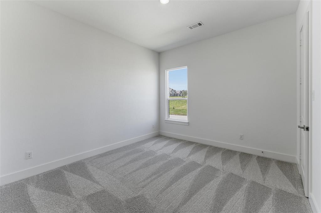 815 Vly Rdg Road Van Alstyne, TX 75495 - Photo 18 of 29 Bright room with a neutral color palette, featuring a single window