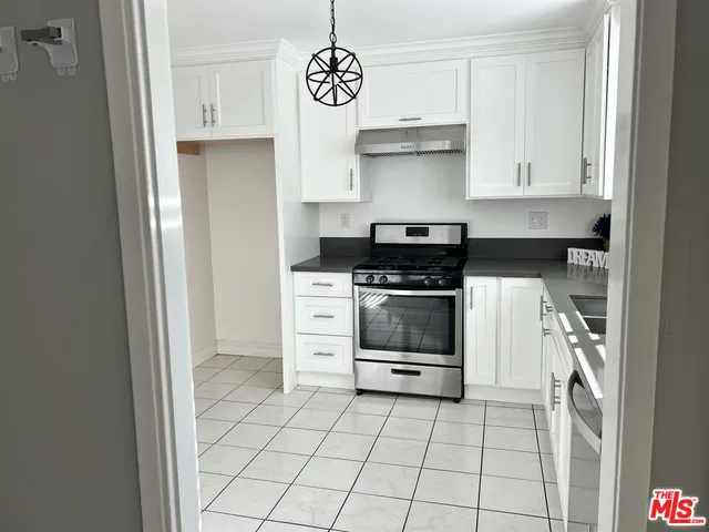 a kitchen with cabinets and appliances