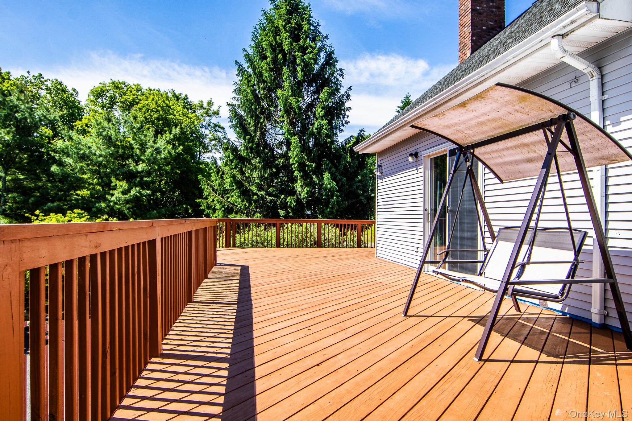 214 West Mombasha Road Monroe, NY 10950 - Photo 18 of 43 a balcony with wooden floor and outdoor space
