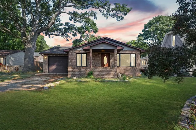 a front view of a house with a garden