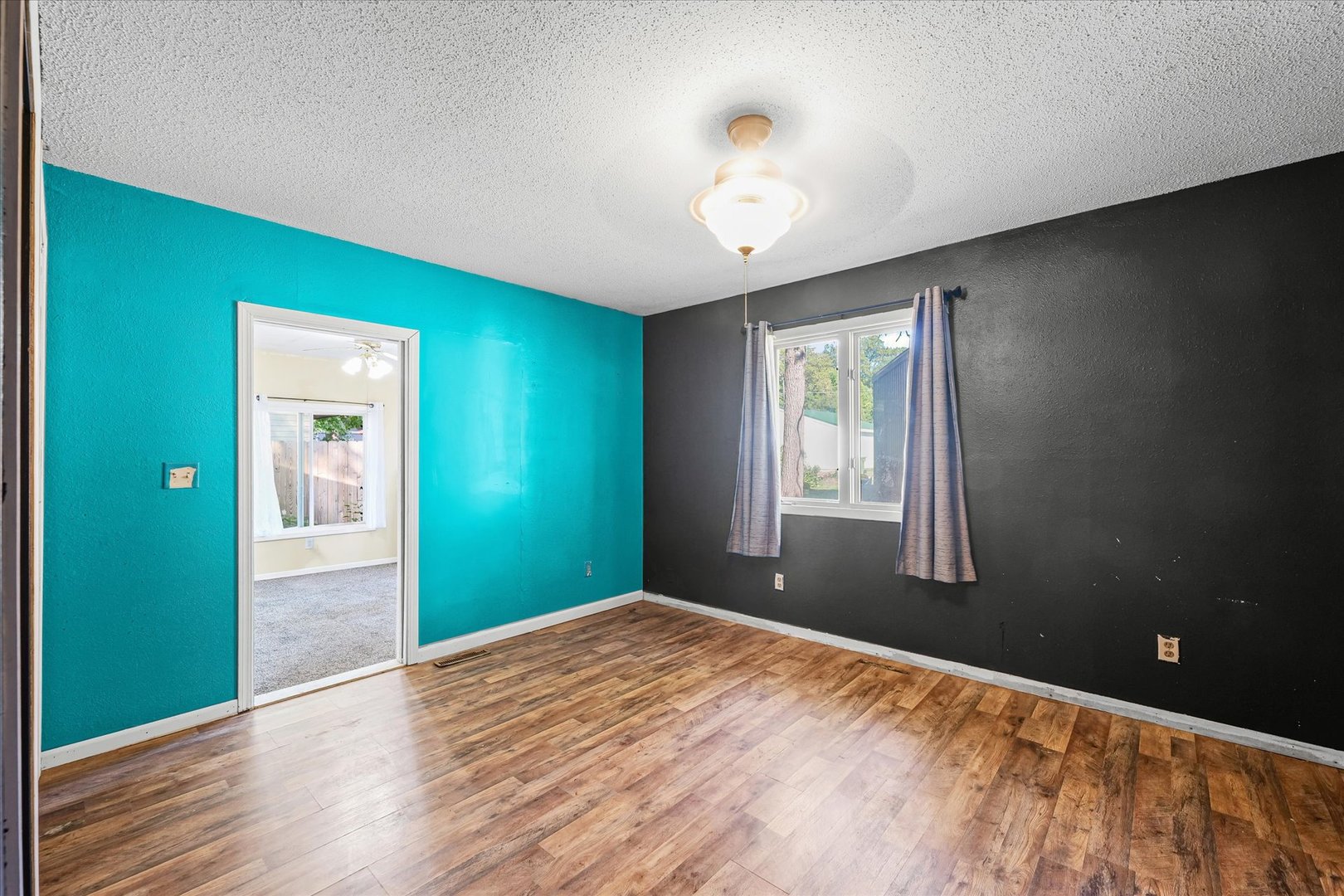106 East Union Street Mahomet, IL 61853 - Photo 14 of 24 a view of an empty room with wooden floor and a window