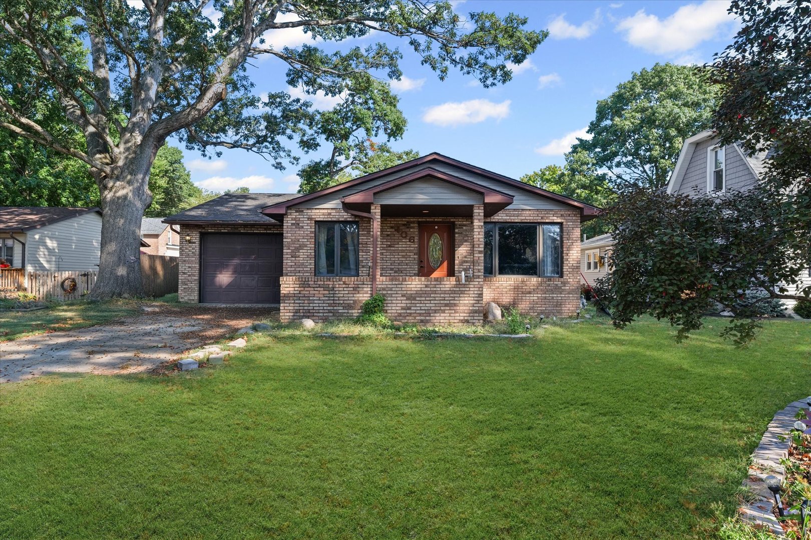 106 East Union Street Mahomet, IL 61853 - Photo 2 of 24 a front view of a house with a garden