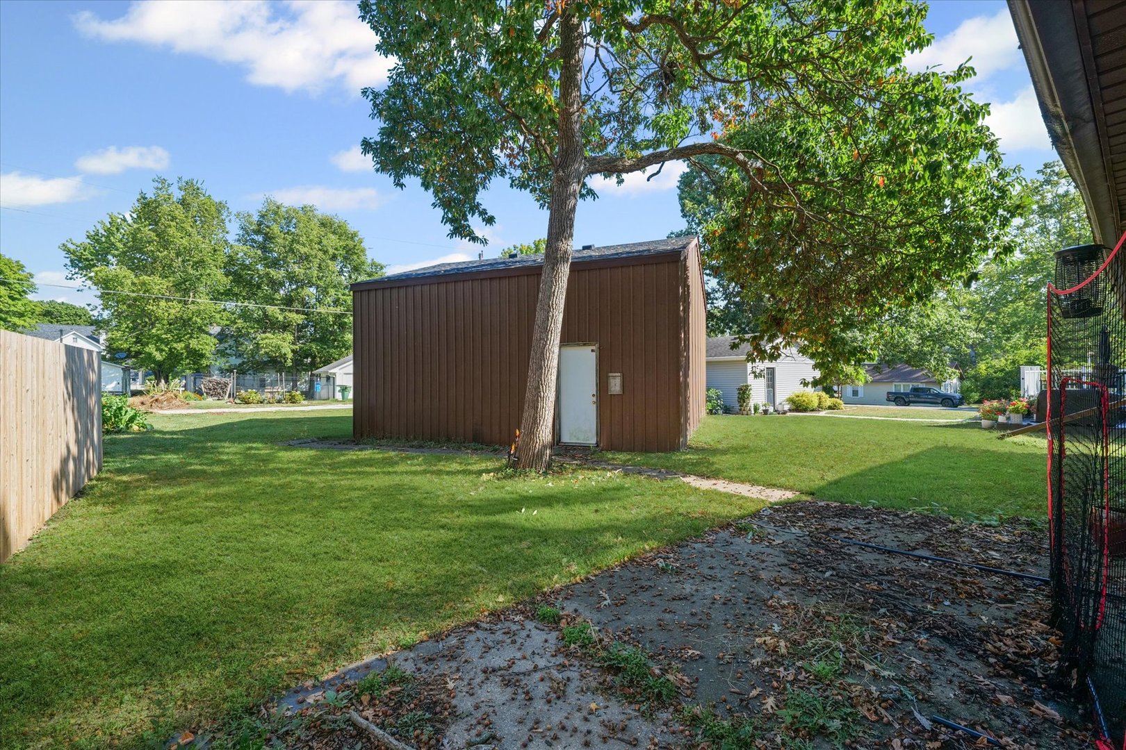 106 East Union Street Mahomet, IL 61853 - Photo 21 of 24 a backyard of a house with plants and large tree