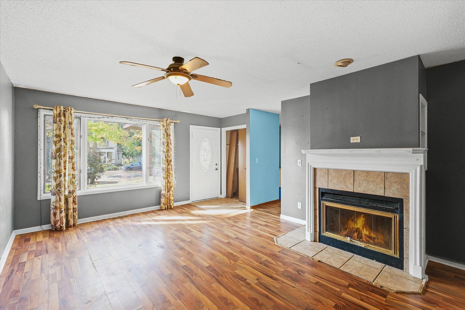 106 East Union Street Mahomet, IL 61853 - Photo 7 of 24 a view of a livingroom with a fireplace and window