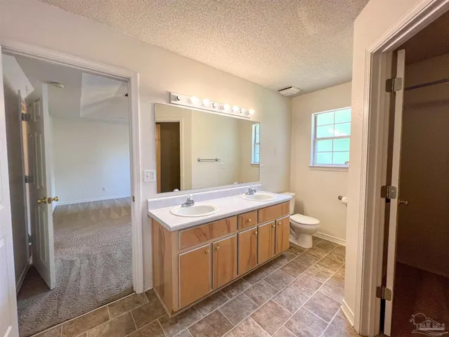 a view of a bathroom with a granite countertop sink and a mirror