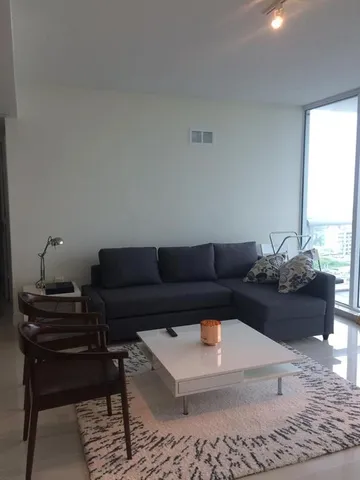 a living room with furniture and a rug