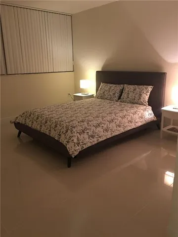 a bedroom with a bed and dresser