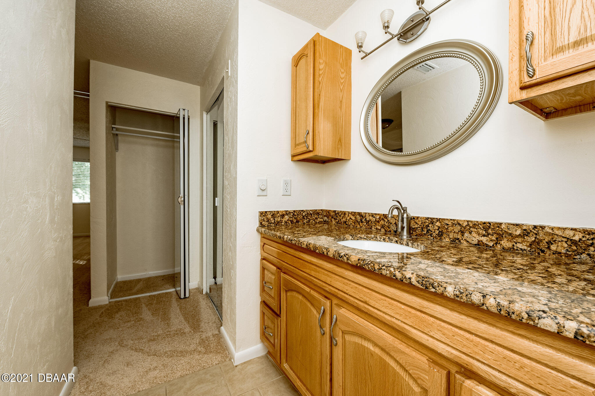 11 Birchwood Trail Ormond Beach, FL 32174 - Photo 17 of 24 a bathroom with a granite countertop sink and a mirror