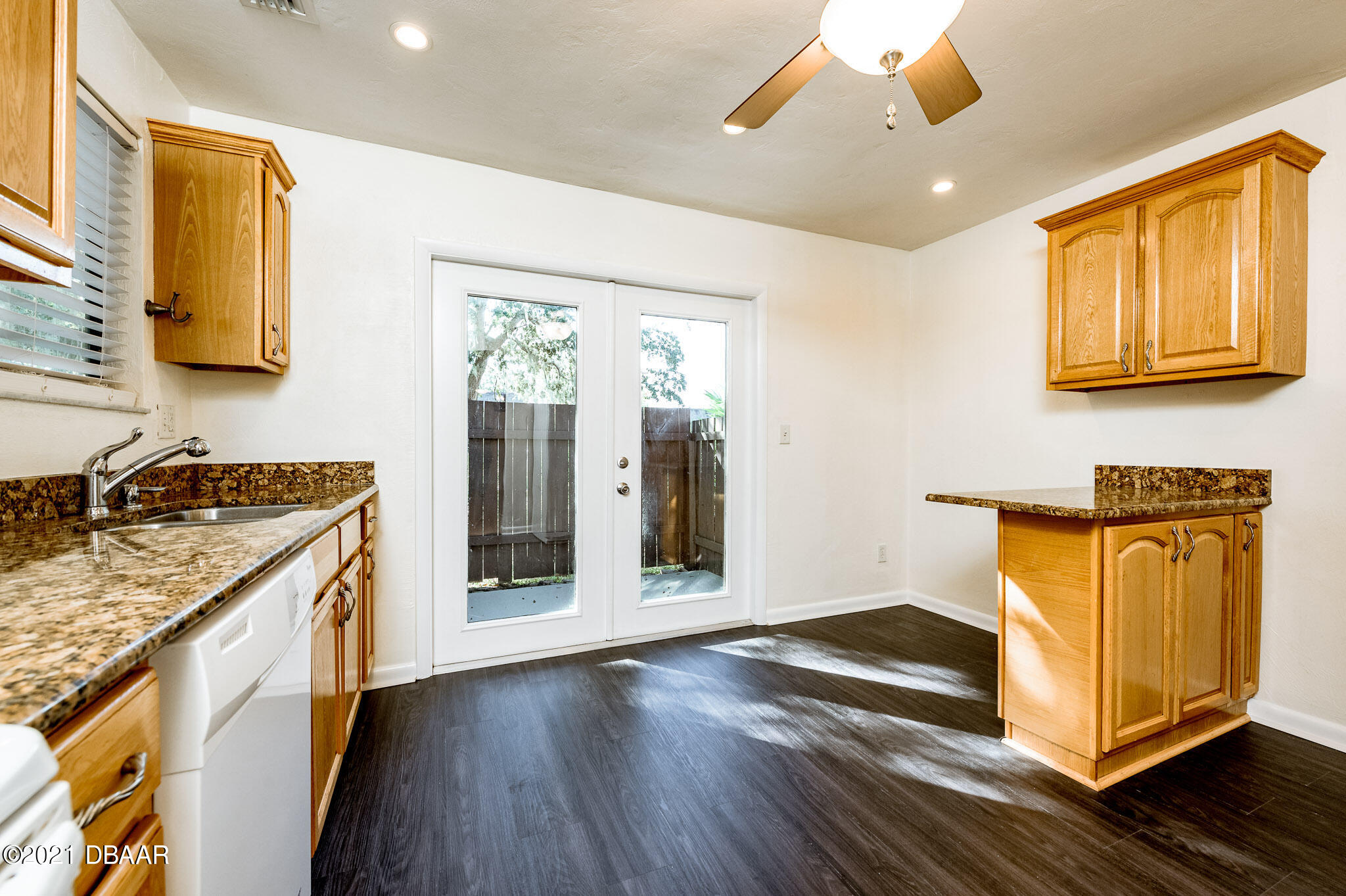11 Birchwood Trail Ormond Beach, FL 32174 - Photo 8 of 24 a bathroom with a granite countertop sink and a washing machine with wooden floor