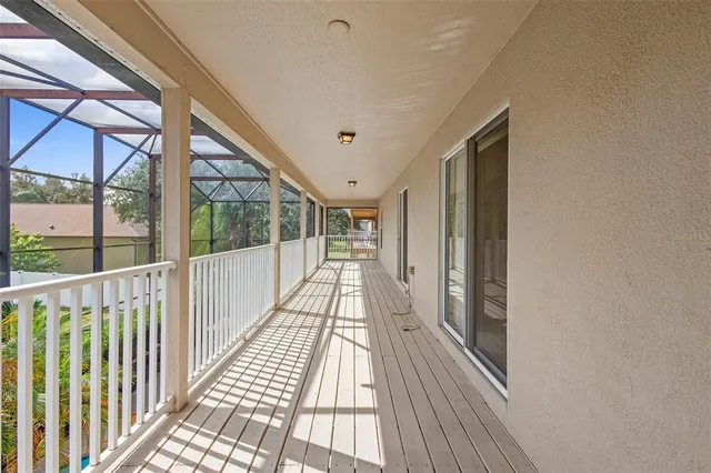 a view of a balcony with wooden floor