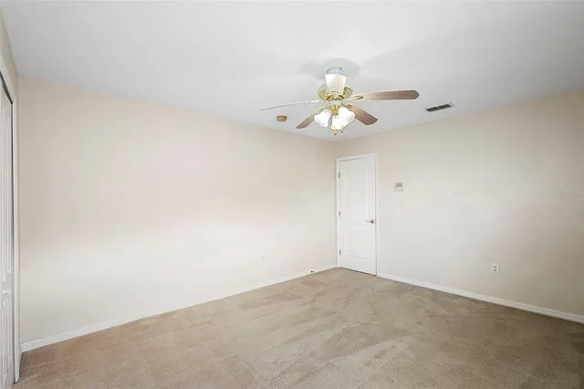 a view of a room with a fan and a window