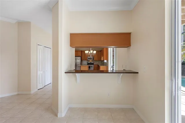 an empty room with closet and a chandelier fan