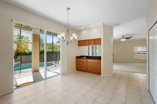 a view of kitchen with refrigerator and window
