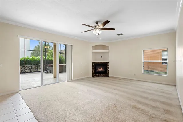 a view of an empty room with a fireplace and a window