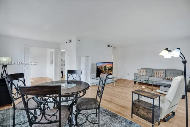 a view of a dining room with furniture wooden floor and a rug