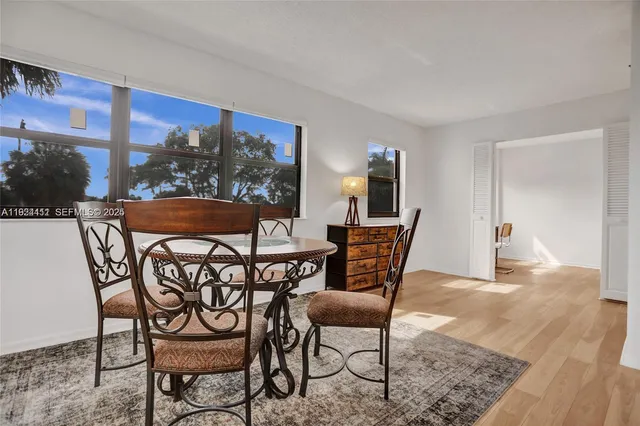 a view of a dining room with furniture and a window