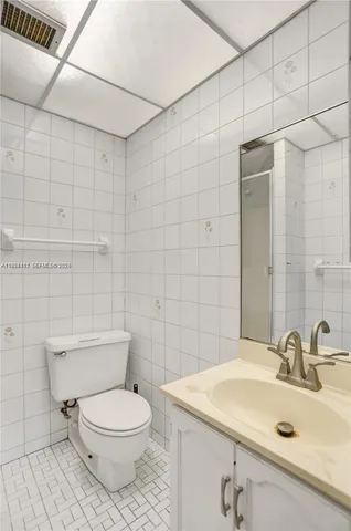 a view of swimming pool with lawn chairs and plants