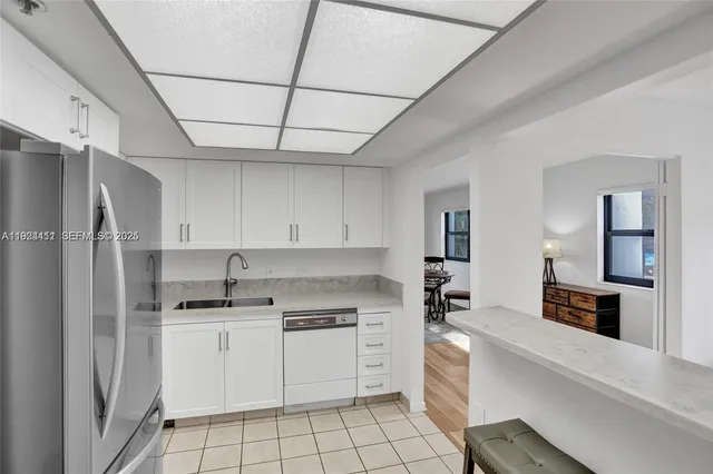 a kitchen with cabinets and appliances