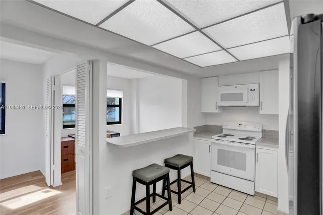 a kitchen with stainless steel appliances a refrigerator sink and cabinets