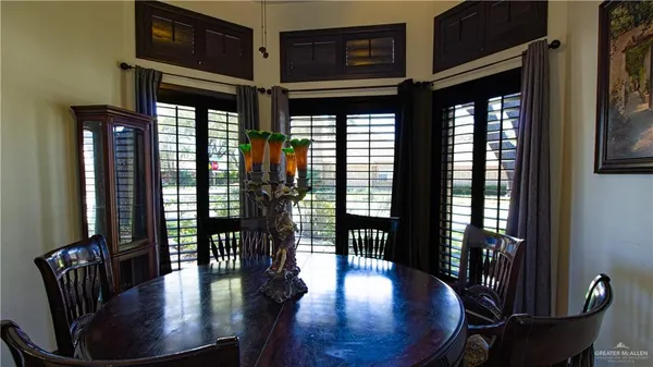 a view of a hallway with wooden floor and windows