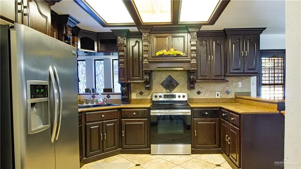 a kitchen with a sink and a stove top oven