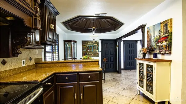 a view of a dining room with furniture and chandelier
