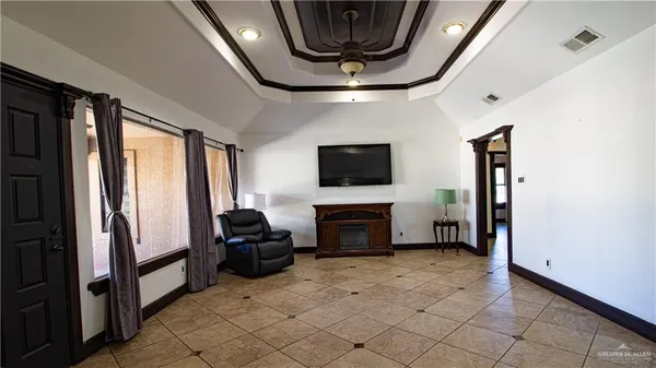 a living room with furniture and large windows