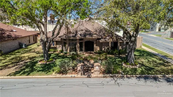front view of a house with a tree