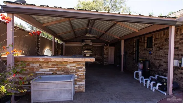 a view of a house with backyard water fountain and sitting area