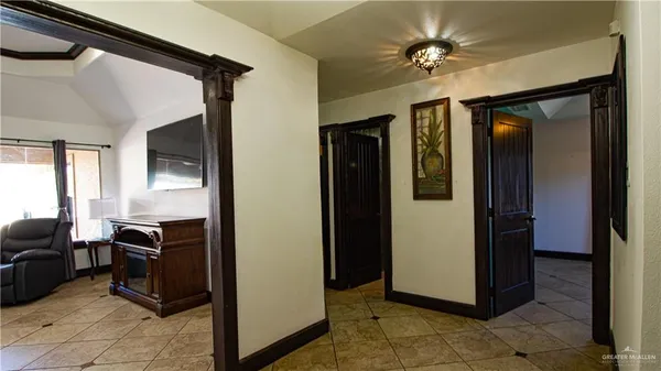 a view of a hallway with workspace and a window