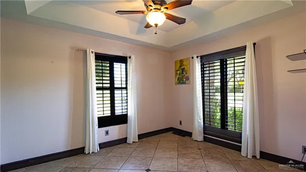 an empty room with windows and closet