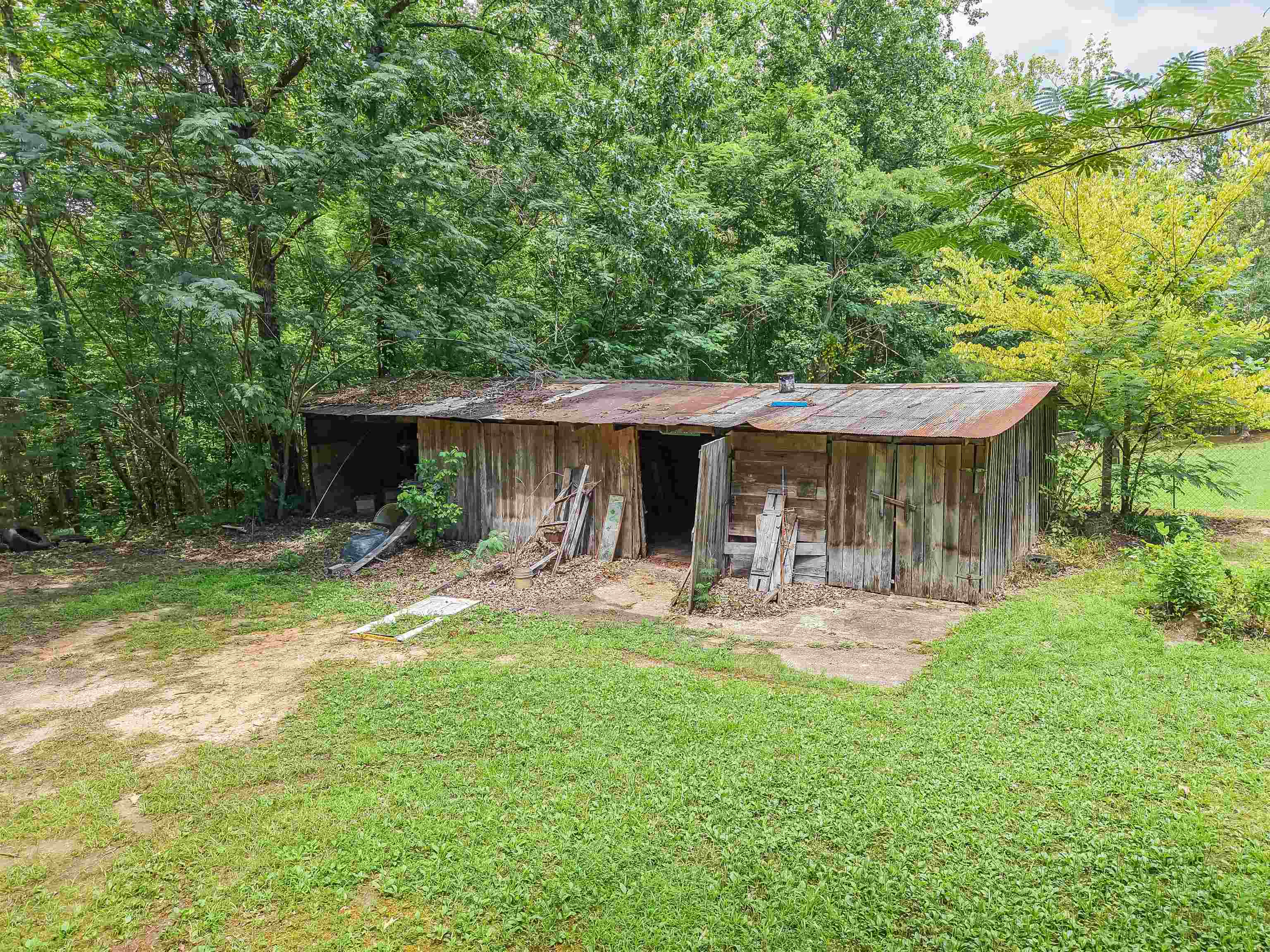 2380 Dunaway Road Selmer, TN 38375 - Photo 38 of 39 Rustic outbuilding with wood siding and a corrugated metal roof