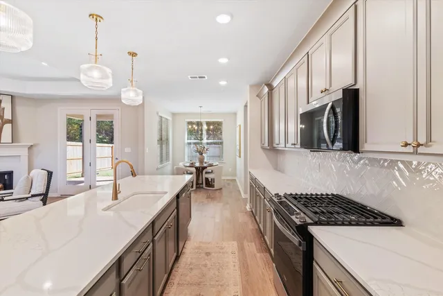 a kitchen with a sink stove and cabinets