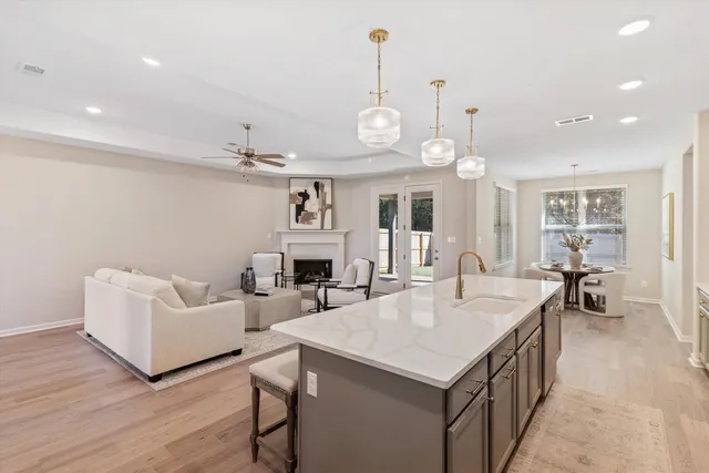 a view of a living room and kitchen with a table chairs