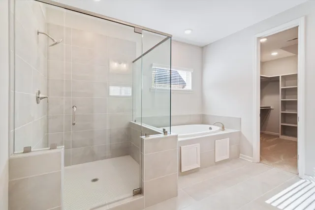 a bathroom with a bathtub a shower a sink and mirror