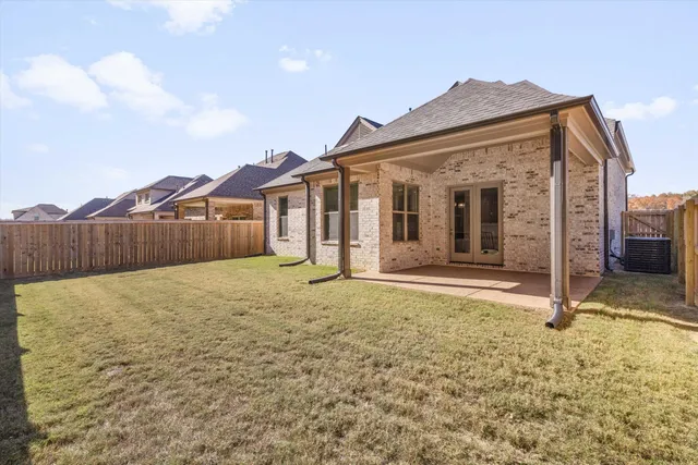 a view of a house with wooden fence