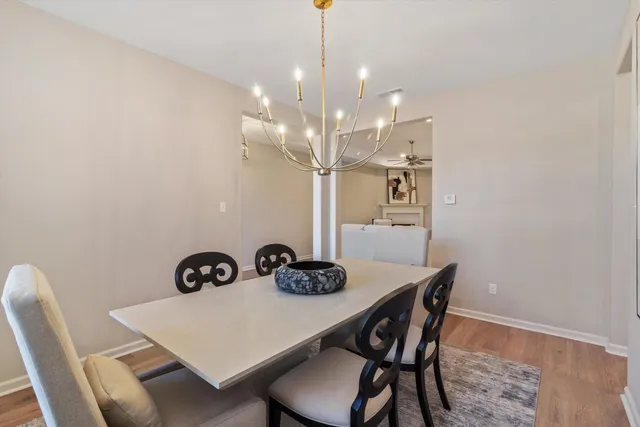 a view of a dining room with furniture and wooden floor